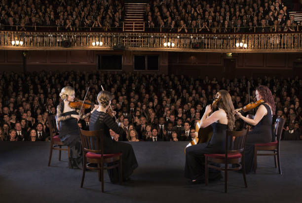 quartet performing on stage in theater - violin women violinist music fotografías e imágenes de stock