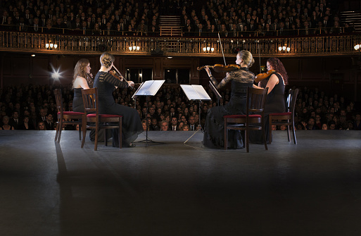 Quartet performing on stage in theater
