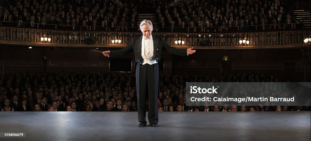 Conductor performing on stage in theater  Musical Conductor Stock Photo