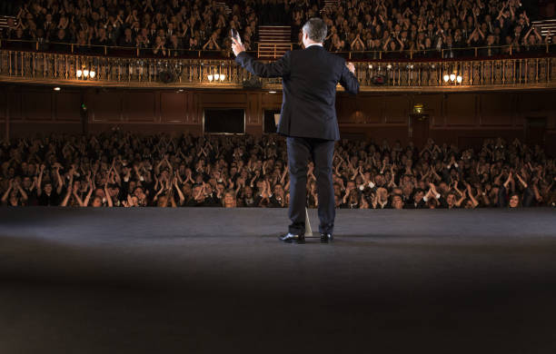 istock Audience clapping for conductor on stage in theater 476806683