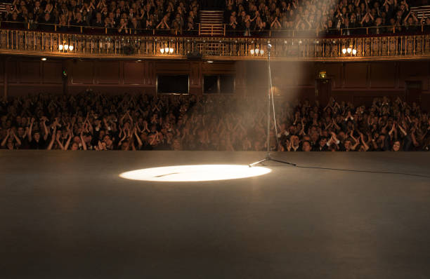 istock Spotlight shining on stage in theater 476806687