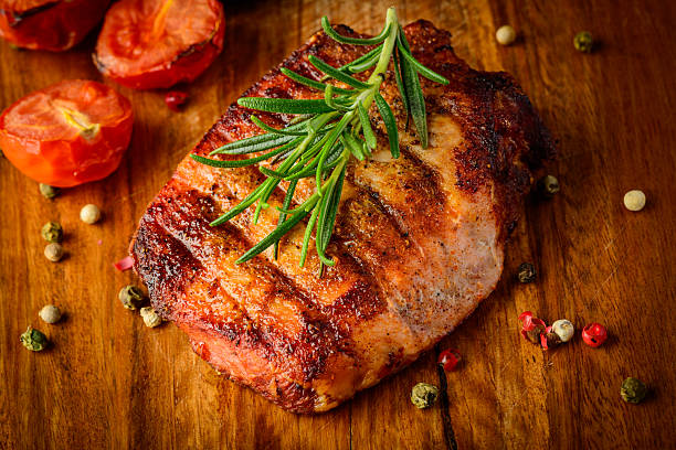 istock Grilled meat on wooden plate 476807159