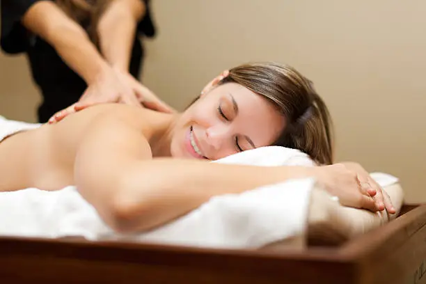 Photo of Young woman receiving a massage