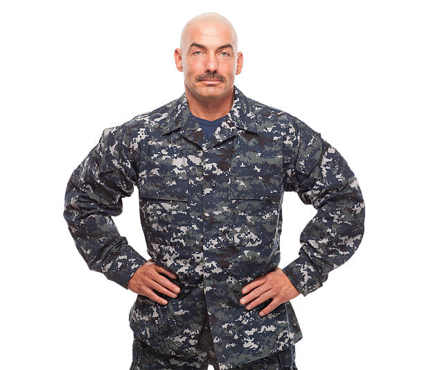 istock Navy sailor or chief looking serious on white background. 476811852