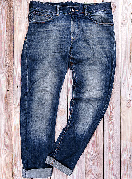 istock Blue jeans trouser isolated on a wooden background 476813478