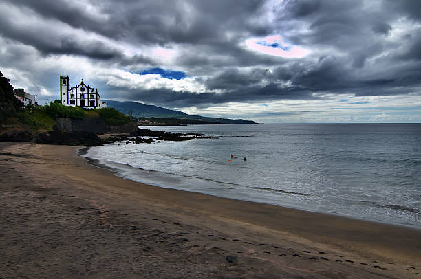 A HDR picture of a white church on the sea in cloudy day in Azores