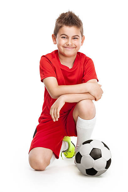 istock kneeling young soccer player with football 476817256