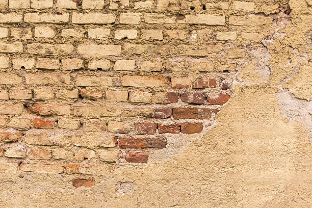 istock Damaged brick wall, closeup shot 476817528