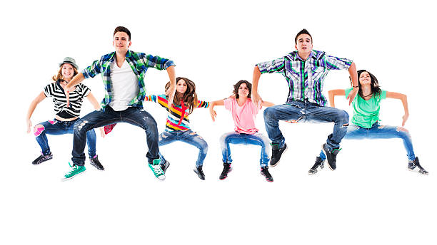 istock Large group of teenage exercising dancing while jumping high up. 476817588
