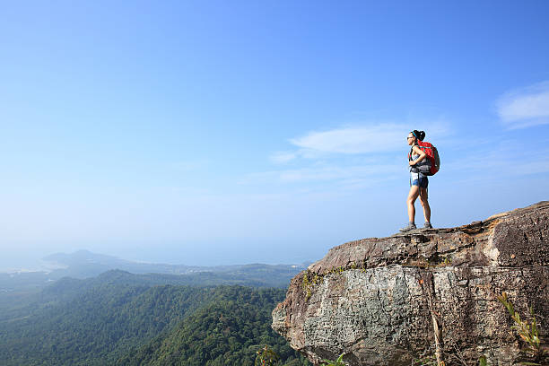 istock young woman hiker at mountain peak 476818036