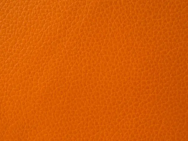 Orange leather texture closeup background.