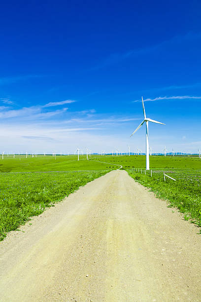 istock wind turbine and meadow under blue sky 476818622