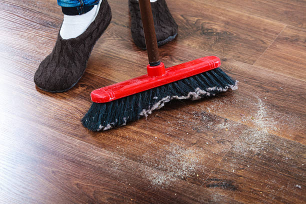 istock Cleaning woman sweeping wooden floor 476818998