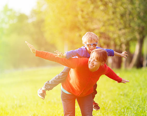 istock mother and son playing in summer park 476819460