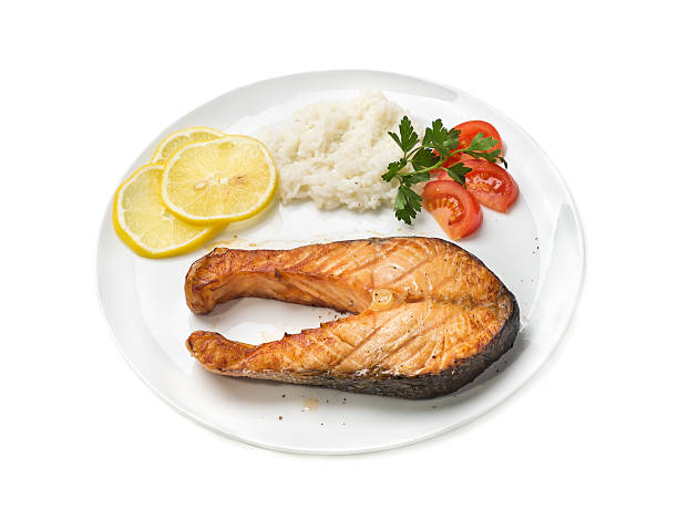 istock Baked trout with vegetables and rice, Isolated on white background 476823654