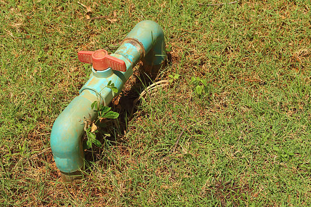 istock water pipes on the green grass 476824386