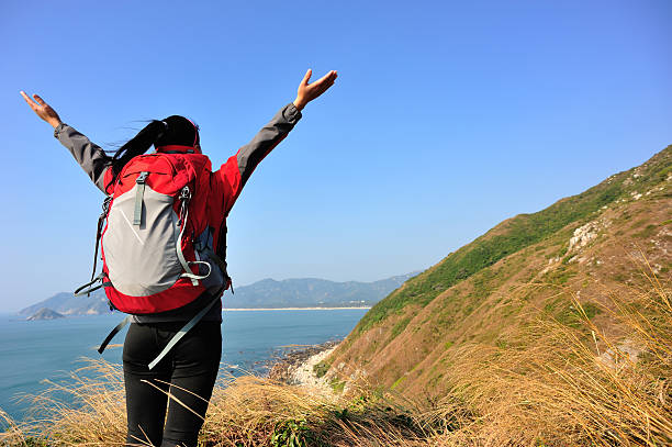 istock cheering hiking woman seaside 476824437
