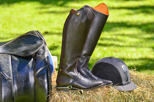 Riding boot, saddle and sport helmet