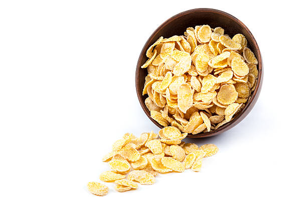 istock Cornflakes in a wooden bowl on white background. 476825838