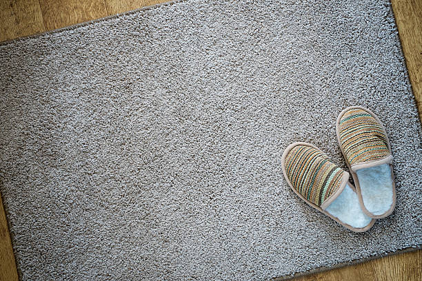 istock Slippers on the mat, top view with space for text 476828786