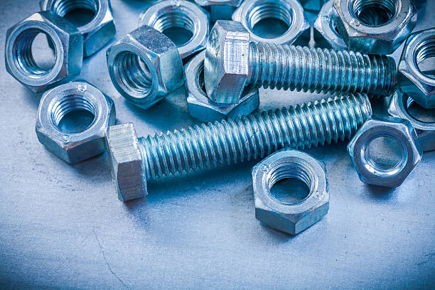 istock Collection of screw nuts and bolts on metallic background constr 476829490