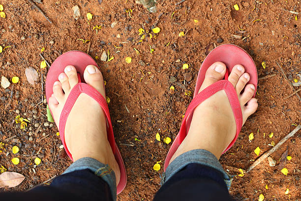 istock People wear sandals on the ground. 476830094