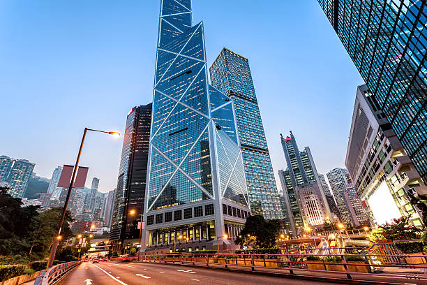 istock traffic light trails and office buildings in modern city 476831046