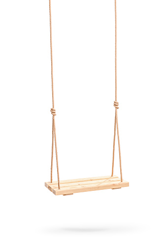 Vertical studio shot of a wooden swing hanging on a couple of ropes isolated on white background
