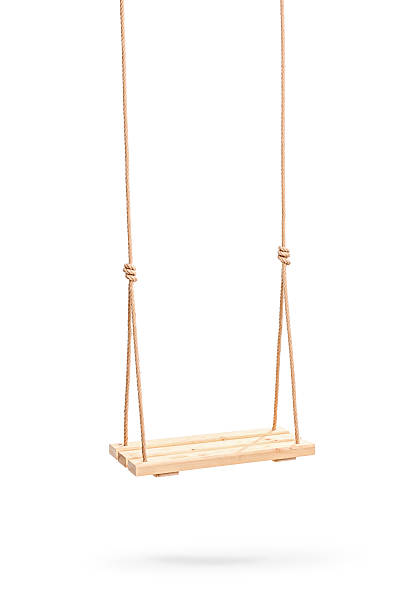Wwooden swing hanging on a couple of ropes Vertical studio shot of a wooden swing hanging on a couple of ropes isolated on white background swinging stock pictures, royalty-free photos & images