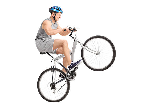 istock Joyful young biker doing a wheelie with his bicycle 476834852