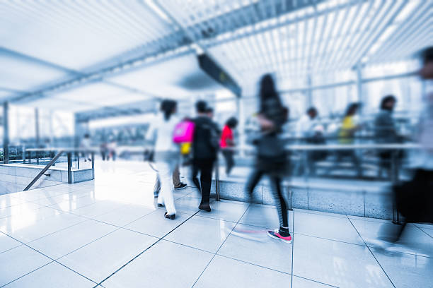 istock Blurred Travellers Pulling Suitcase Along Hallway in Airport 476836627