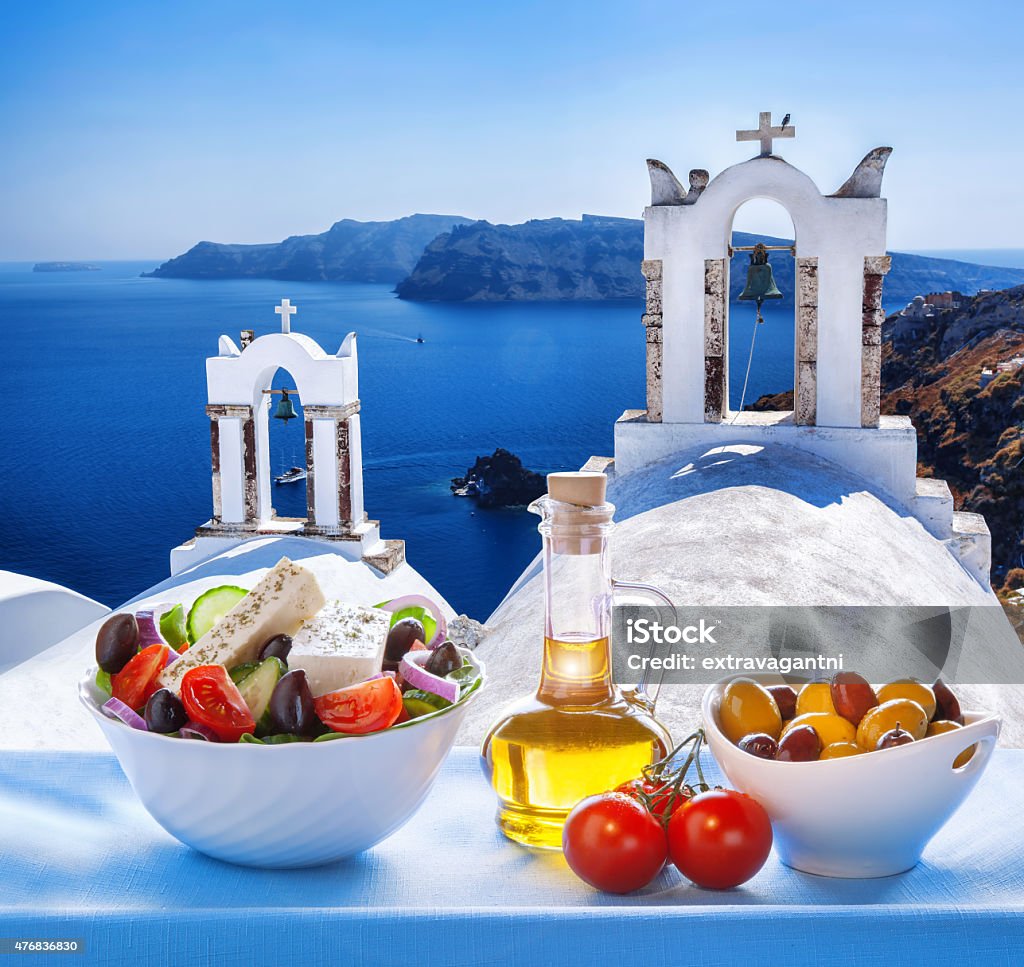 Greek salad in Santorini island, Greece Greek salad in Santorini island against famous windmills, Oia, Greece Greek Food Stock Photo