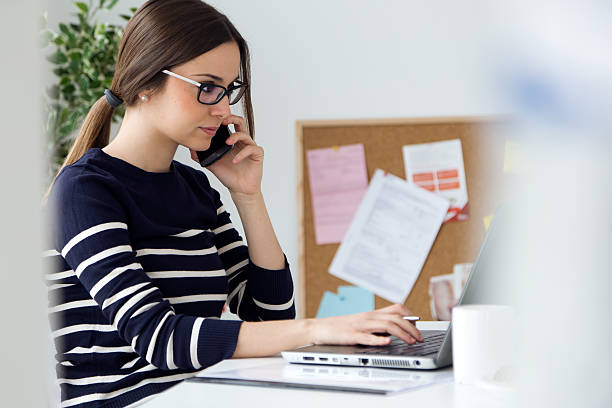 istock Confident young woman working in her office with laptop. 476836852