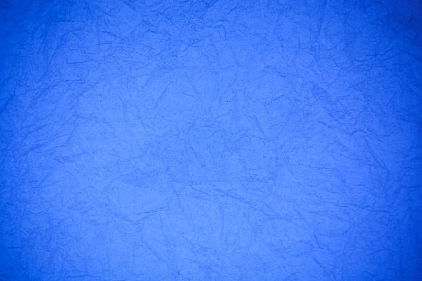 istock Crumpled vintage blue paper textured obsolete background. 476840494