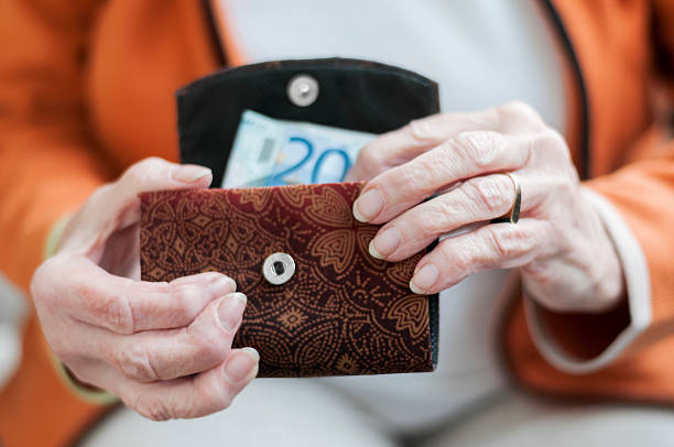 istock Senior women looks in her purse 476840820