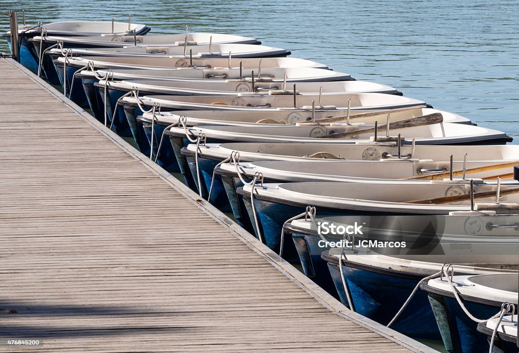 Boats moored in a row Boats moored in a row on the lake of Retiro, Madrid, Spain 2015 Stock Photo
