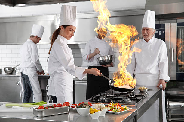 istock Female chef Cooking oyster in framing pan. 476845468
