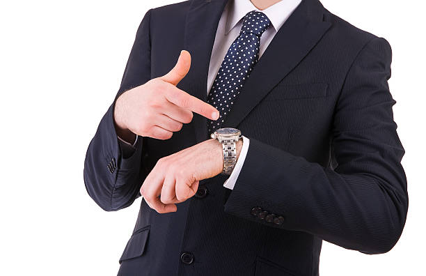 istock Businessman pointing at his wristwatch. 476846824