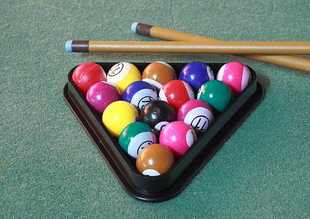 istock Pool balls on green cloth in triangle with cues 476847237