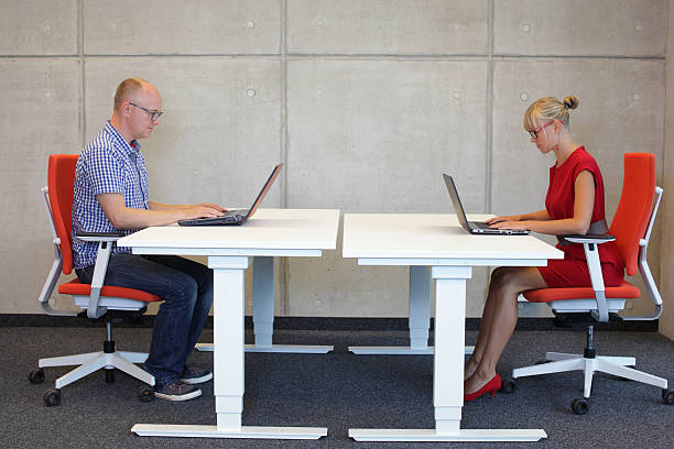 istock man and woman  in correct sitting posture at workstations 476850994