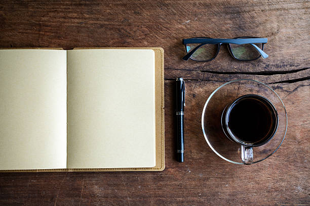 istock Cup of coffee with notebook on old wood 476851848