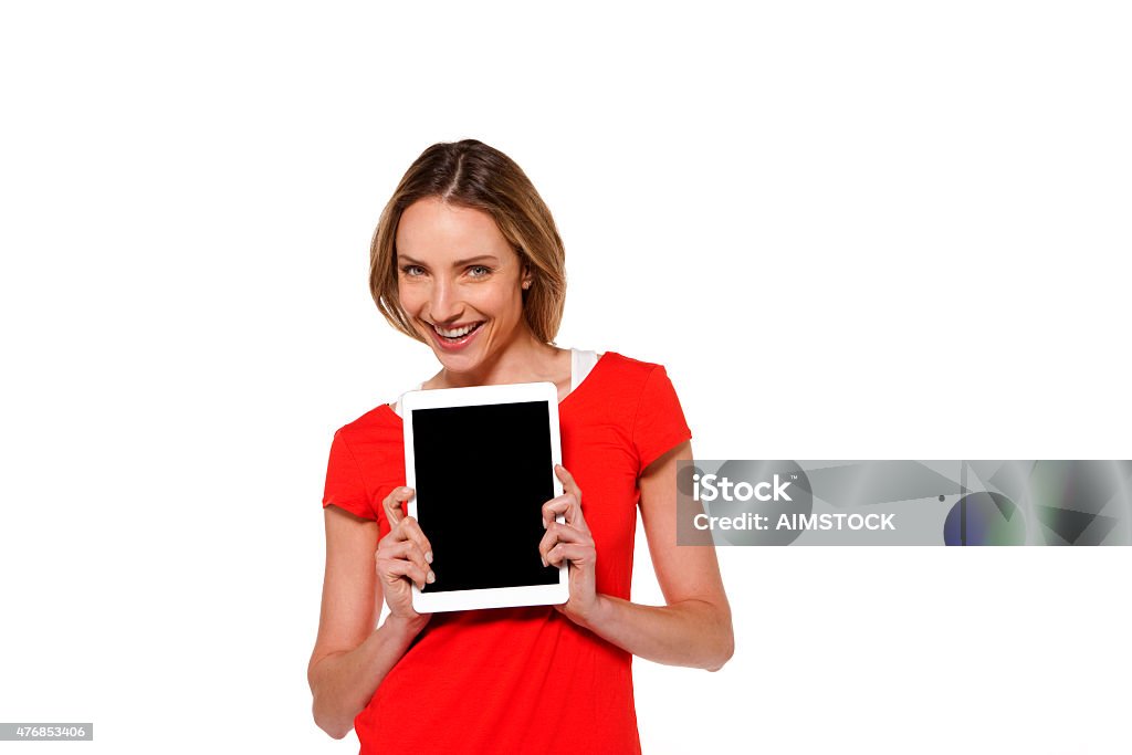 Woman holding a tablet PC Happy woman wearing a plain red top holding a tablet pc. Isolated on white. Happiness Stock Photo