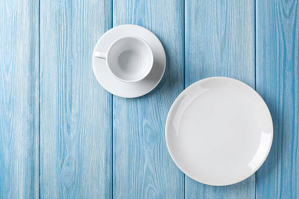 istock Empty plate and coffee cup on blue wooden background 476855636