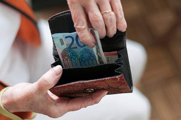 istock Senior women looks in her purse 476857492
