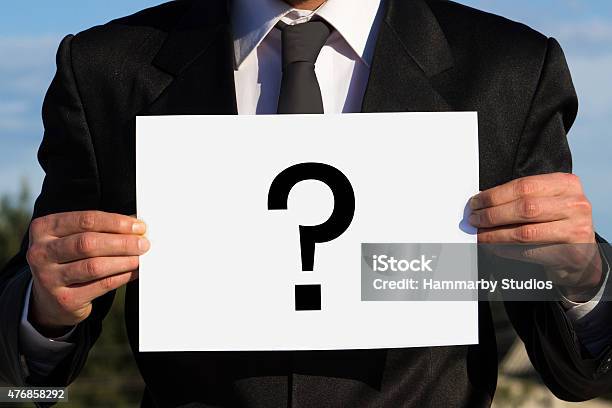 Unrecognizable Businessman Holding A Question Mark On Poster Stock Photo - Download Image Now