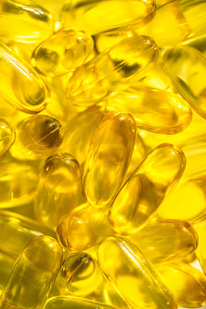 istock Gel capsules isolated on white. Vitamin D 476858332