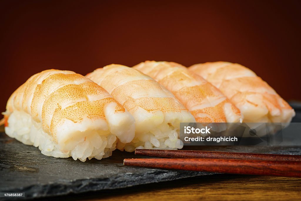 Nigiri sushi with shrimps closeup detail of nigiri sushi with shrimps and chopsticks Asian Culture Stock Photo