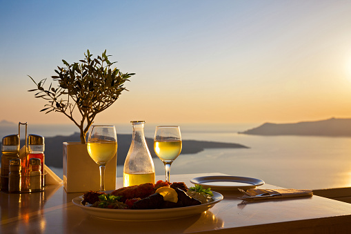 Romantic table for two on the island Santorini, Greece. Views of the sea and the volcano