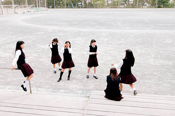 istock Japanese high school. Female students relax during break, school playground 476863530