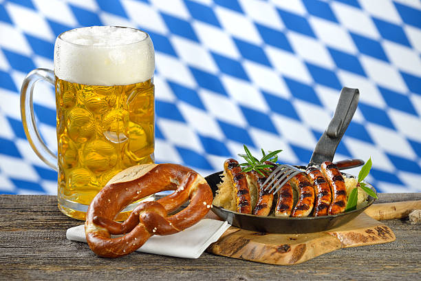 Bavarian cuisine Fried Nuremberg sausages on sauerkraut with a mug of Bavarian beer and a pretzel oktoberfest food stock pictures, royalty-free photos & images